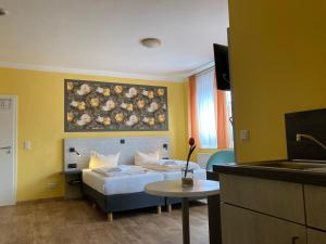 een hotelkamer met 2 bedden en een tafel bij Landhotel Vosse-Schepers in Rhede