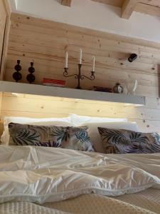 a bedroom with a bed with candles on the wall at NIKOLIJA 3 in Bajina Bašta +10 photos