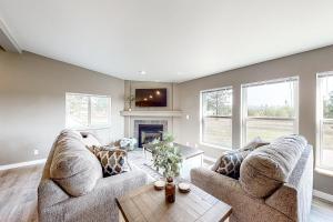 a living room with two couches and a fireplace at Idahome in Athol