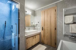 a bathroom with a sink and a toilet and a shower at Chalet Martina Apartments in San Vigilio Di Marebbe +8 photos