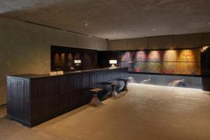 a lobby with a bar with stools in a room at THE HOTEL HIGASHIYAMA KYOTO TOKYU, A Pan Pacific Hotel in Kyoto +60 photos