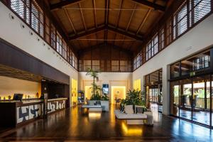 a lobby with couches and tables in a building at Barceló Tenerife in San Miguel de Abona