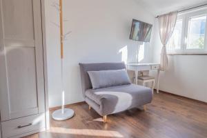 a living room with a chair and a desk at Villa ARIA VALLIS in Tribalj
