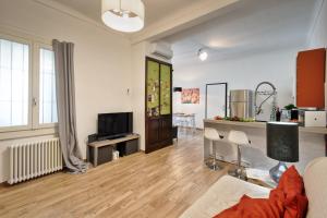 a living room with a couch and a tv at Casa LENA by Apartments To Art in Turin