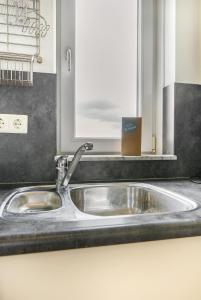 a stainless steel sink in a kitchen with a window at Hello Zeeland - Appartement Port Scaldis 19-031 in Breskens