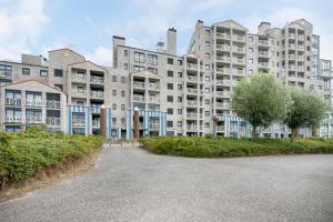 a large apartment building with trees in front of it at Hello Zeeland - Appartement Port Scaldis 19-031 in Breskens