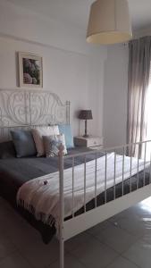 a bedroom with a large white bed with a canopy at Fuzeta beach holiday apartment in Fuzeta