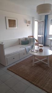 a living room with a couch and a table at Fuzeta beach holiday apartment in Fuzeta