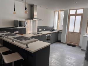 a kitchen with a sink and a stove top oven at Wine house in Chablis