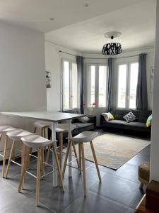 - un salon avec une table et des tabourets dans l'établissement Le triomphe logement central, 8 pax 3 chambres, à Marseille