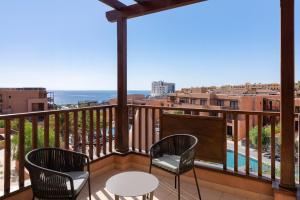 a balcony with chairs and a view of the ocean at Barceló Tenerife in San Miguel de Abona