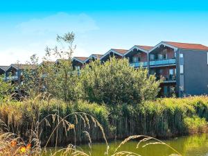 a row of houses next to a body of water at 4 person holiday home in Bogense in Bogense