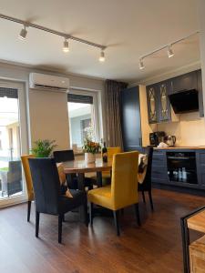 a kitchen and dining room with a table and chairs at Luxury Maślice Apartment in Wrocław