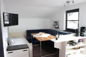a small kitchen with a table and a tv at Apartments Hermann Arnold in Sölden