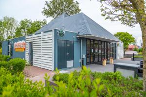 ein Gebäude mit einer blau-weißen Fassade in der Unterkunft EuroParcs Markermeer in Bovenkarspel