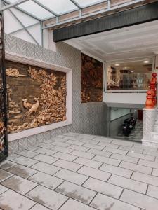 a large painting on the wall of a building at thiên phú hotel in Ho Chi Minh City