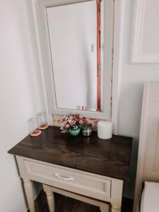 a bathroom vanity with a mirror and flowers on it at thiên phú hotel in Ho Chi Minh City +9 photos