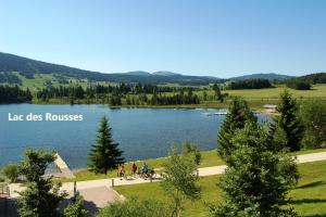 a lake with a sign that reads last bikes roses at Sauna en bord de rivière in Morez