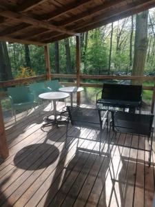 a patio with tables and chairs on a wooden deck at Wiking in Turawa