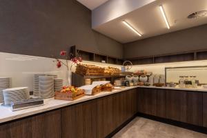 a kitchen with a counter with food on it at Radisson Blu Hotel Erfurt in Erfurt