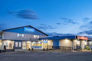 a store front of a building with a sign on it at Travelodge by Wyndham Fort St John in Fort Saint John