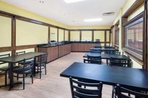 a classroom with tables and chairs in a cafeteria at Travelodge by Wyndham Fort St John in Fort Saint John
