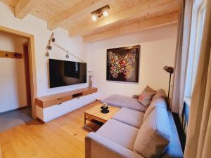 a living room with a couch and a flat screen tv at Mei-Chalet in Bad Kleinkirchheim