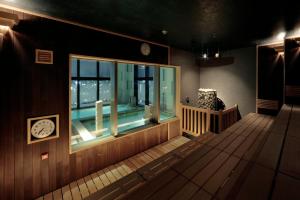 um quarto com uma janela e um relógio na parede em Candeo Hotels Kumamoto Shinshigai em Kumamoto