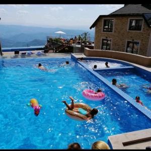 a group of people playing in a swimming pool at Apartman Marija M13 Milmari in Kopaonik