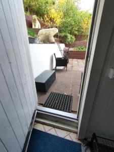 an open door with a bench on a porch at Studio White Bears in Akureyri