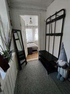 a living room with a mirror and a bed at Studio White Bears in Akureyri