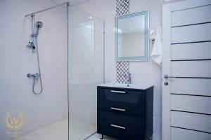 a bathroom with a shower and a sink and a mirror at Welcome Inn Hotel in Yerevan