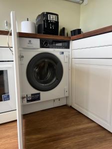 a washer and dryer sitting in a kitchen at CityView Apartment in Tallinn