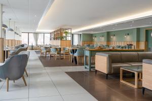 a restaurant with tables and chairs and a cafeteria at Aberystwyth Park Lodge Hotel in Aberystwyth