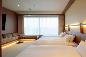 Candeo Hotels Kumamoto Shinshigai房間的床