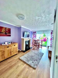 sala de estar con chimenea, mesa y sillas en 3 bed house in Walsall, perfect for contractors & leisure & free parking, en Walsall