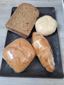 una placa negra con tres tipos diferentes de pan. en B&B Mooi Betuwe en Tiel