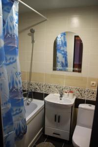 a bathroom with a sink and a toilet and a mirror at Hotel Lyuks in Arzamas