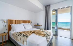 1 dormitorio con 1 cama y vistas al océano en Dia's Blue Villa, en Gournes