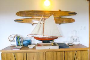 a wooden model boat on top of a dresser at Bridgecroft Beach Shack blissful spa retreat for 6 in Port Arthur