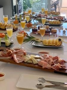 a buffet of food with cheese and meats and drinks at Calatabarca B&B in Tabarca