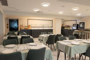 a room with tables and chairs and a cafeteria at Modern Revival Luxury Hotel in Thessaloniki