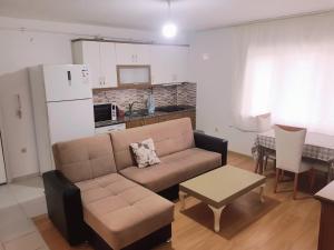 ein Wohnzimmer mit einem Sofa und einem Tisch sowie eine Küche in der Unterkunft 33 Hotel two bedrooms Appartment 15 min from Istanbul airport in Habipler