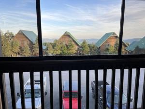 a balcony with a view of a parking lot with cars at Newly renovated 4 bedroom condo. Short 150 yard walk to ski lift. Hot tubs. in Snowshoe