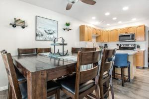 a kitchen and dining room with a wooden table and chairs at Bear Lake Blue in Garden City