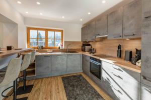 a kitchen with wooden counters and stainless steel appliances at Silberleithen Estate in Biberwier