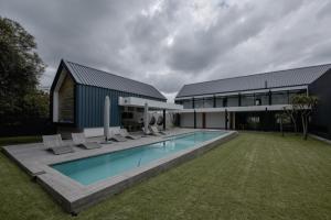 a house with a swimming pool next to a building at Askara Haus in Pretoria