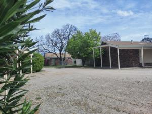 a brick house with a driveway in front of it at Belvoir Village Motel & Apartments Wodonga in Wodonga