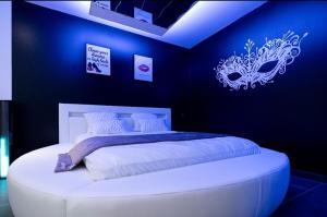 una camera con un letto in una camera blu di L'OLYMPE DES SENS a Portiragnes
