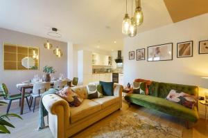 a living room with a couch and a dining room at Bressingham - 2 Bedroom Luxury Apartment by Mint Stays in Bristol